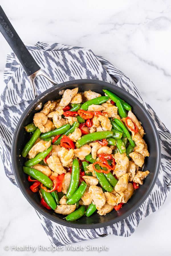 Orange Chicken and vegetables in a frying pan.