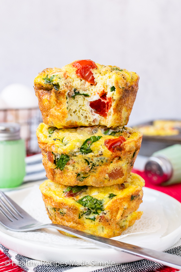 3 keto egg muffins stacked on top of each other.