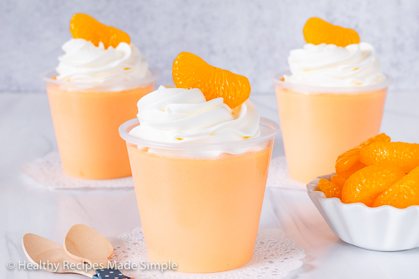 Rectangle shot of 3 cups of orange protein jello.