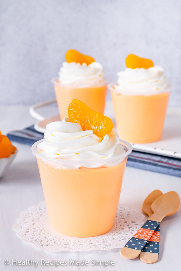 Orange protein jello in a cup.