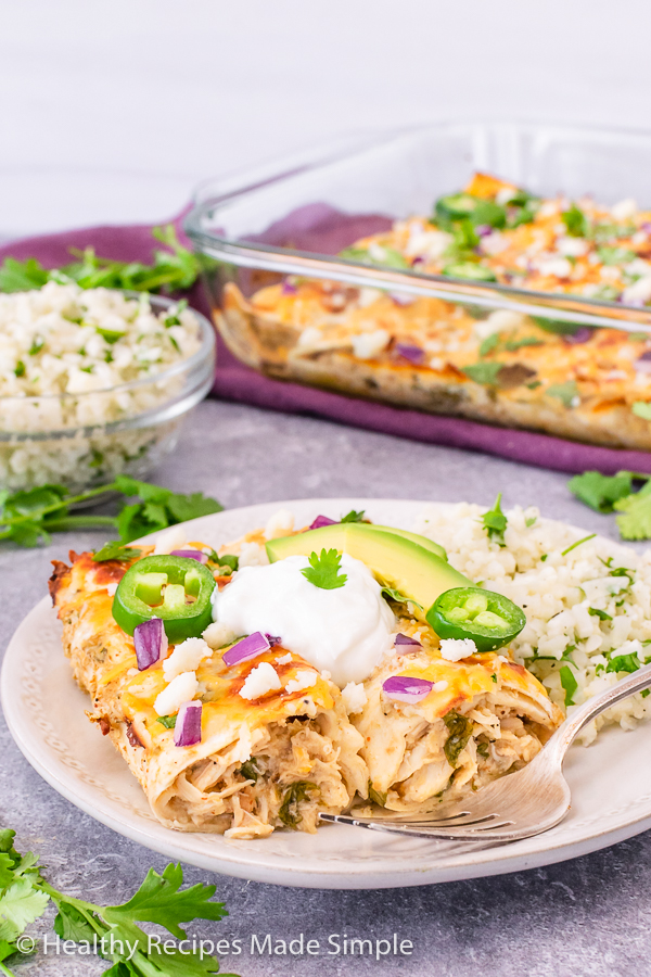 Healthy chicken enchiladas on a place with cauliflower rice.