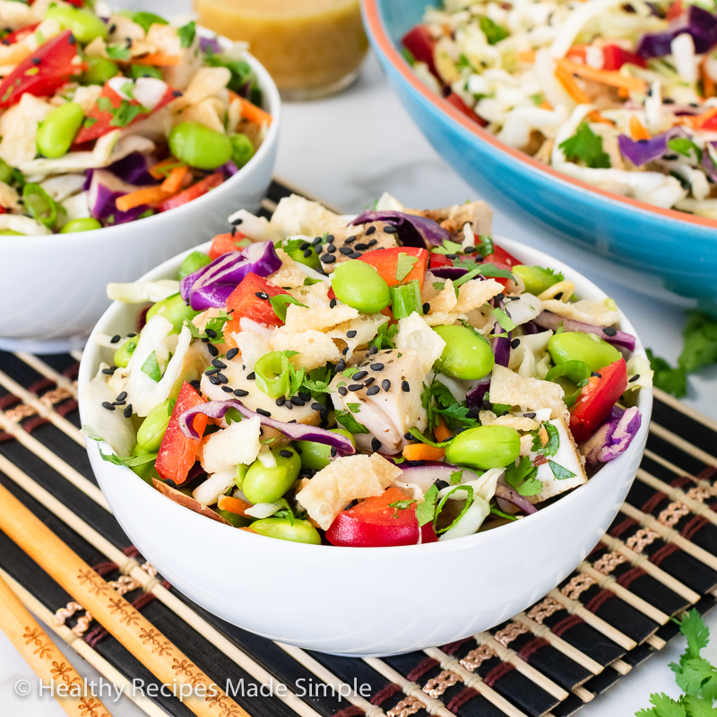 Front picture of a bowl of cabbage salad with chicken in a white bow.