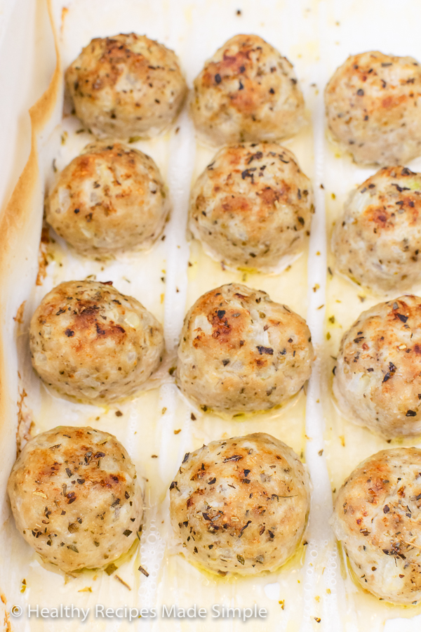 A close up picture of meatballs on a pan.