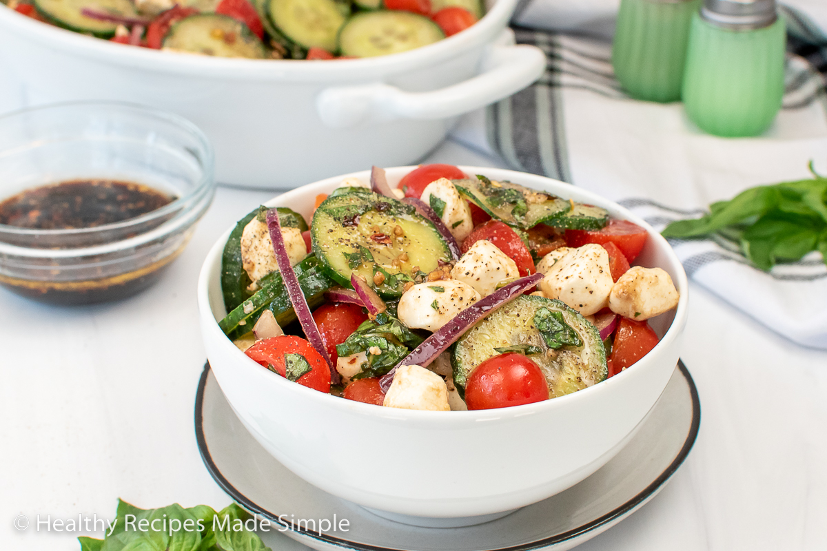 A bowl of tomato cucumber mozzarella salad.