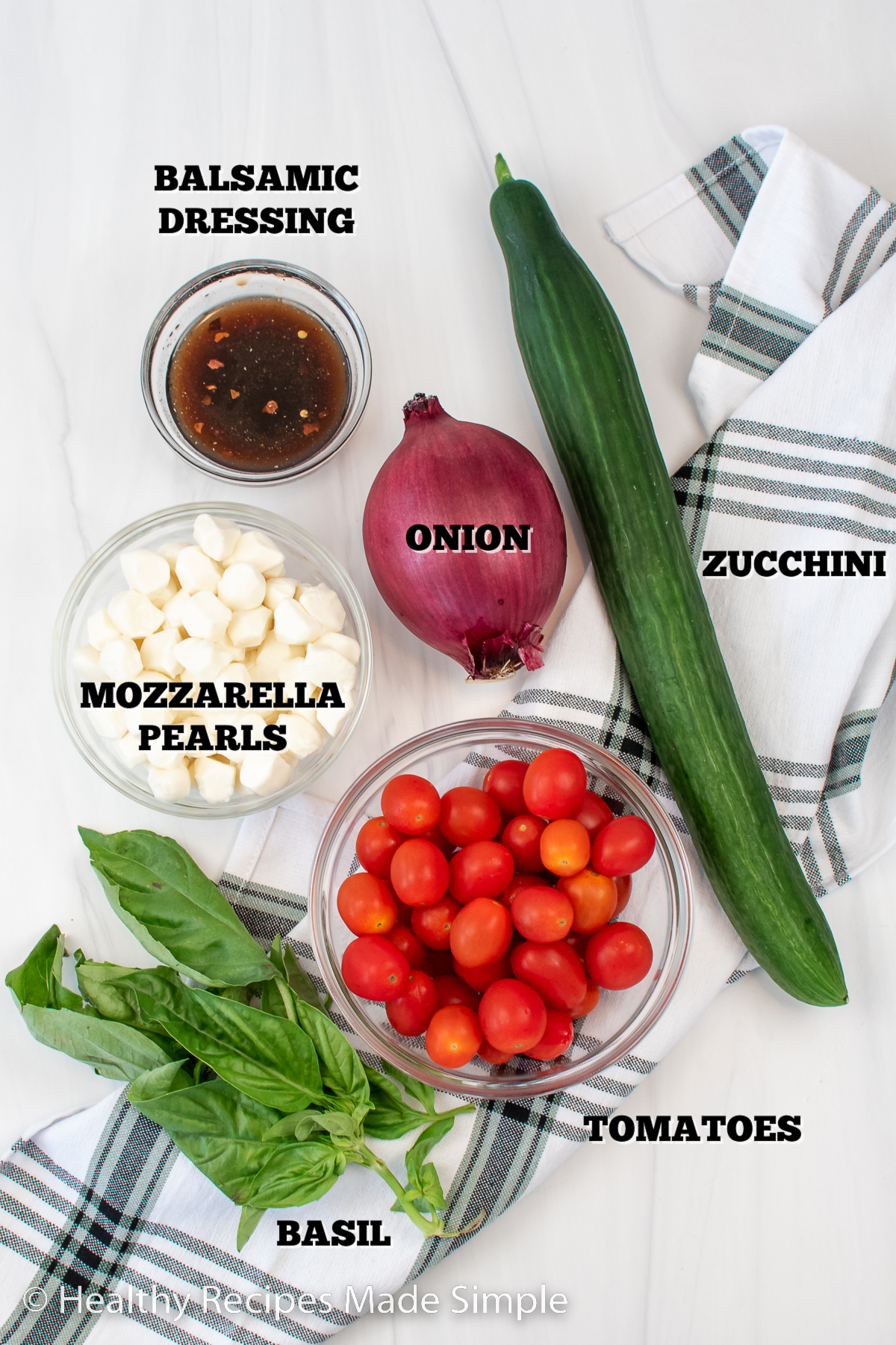 All the ingredients you need for a Tomato Cucumber Mozzarella Salad.