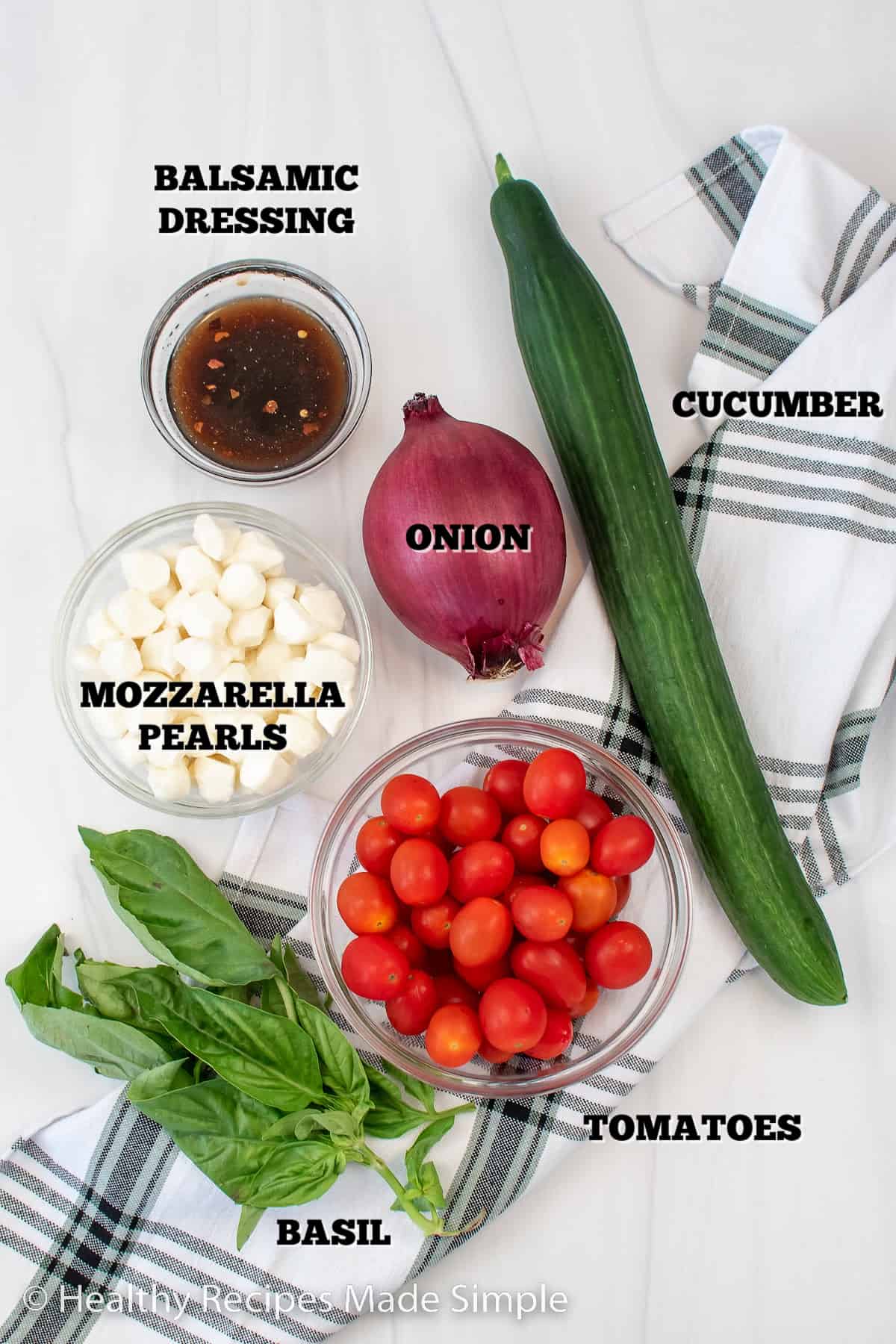 All the ingredients you need for a Tomato Cucumber Mozzarella Salad.