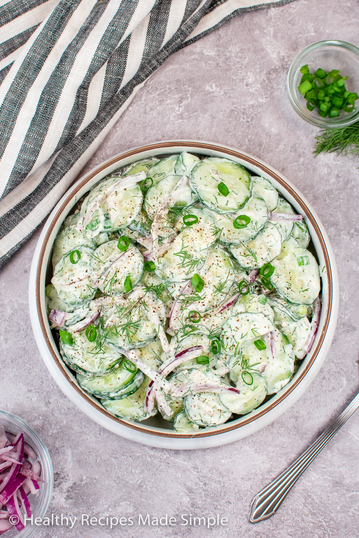 An overhead picture of a bowl filled with Dill Yogurt Cucumber Salad.