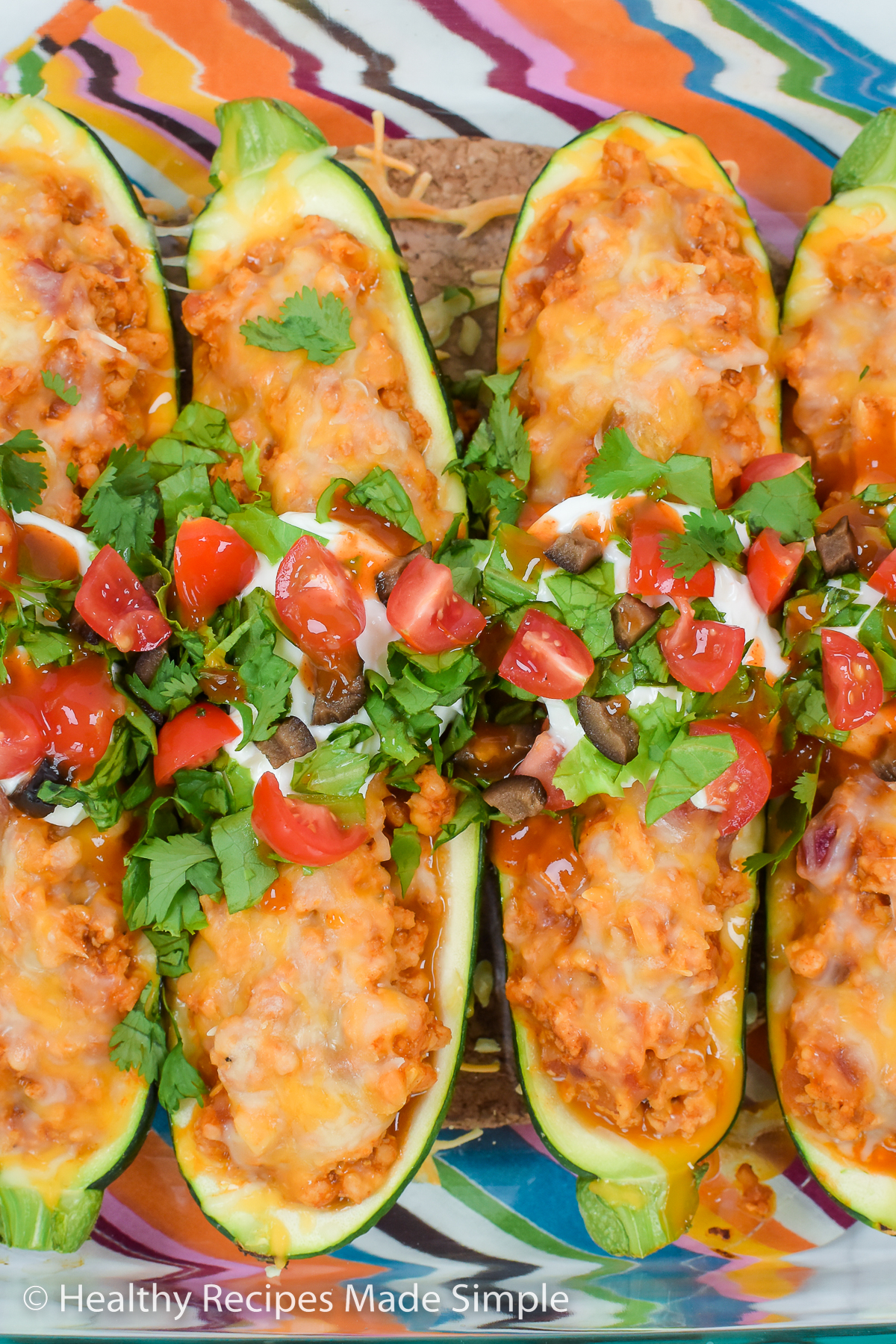 Topping on prepared zucchini boats.