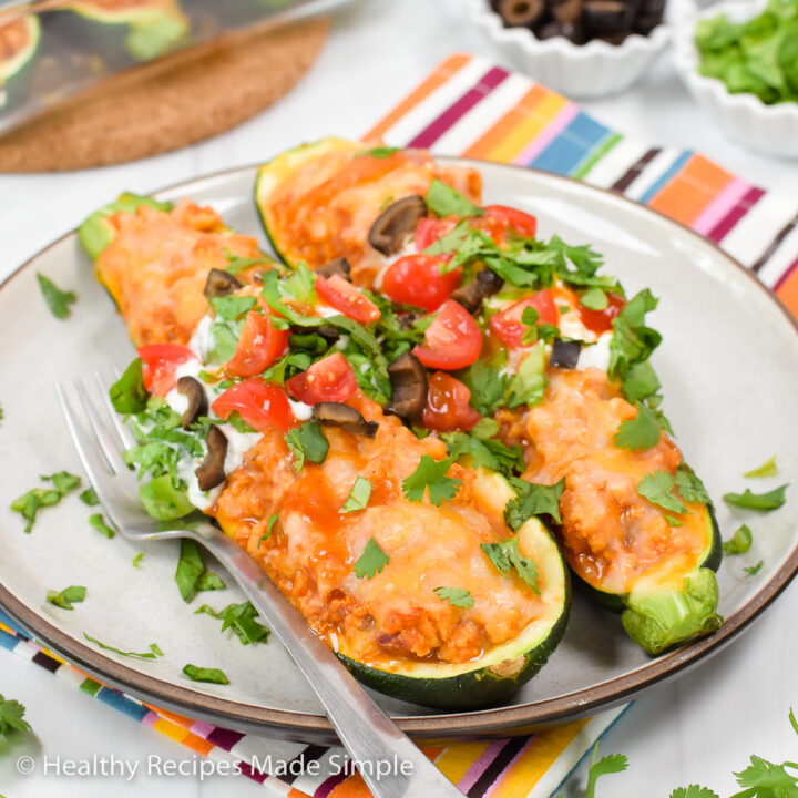 Taco Stuffed Zucchini on a tan plate.