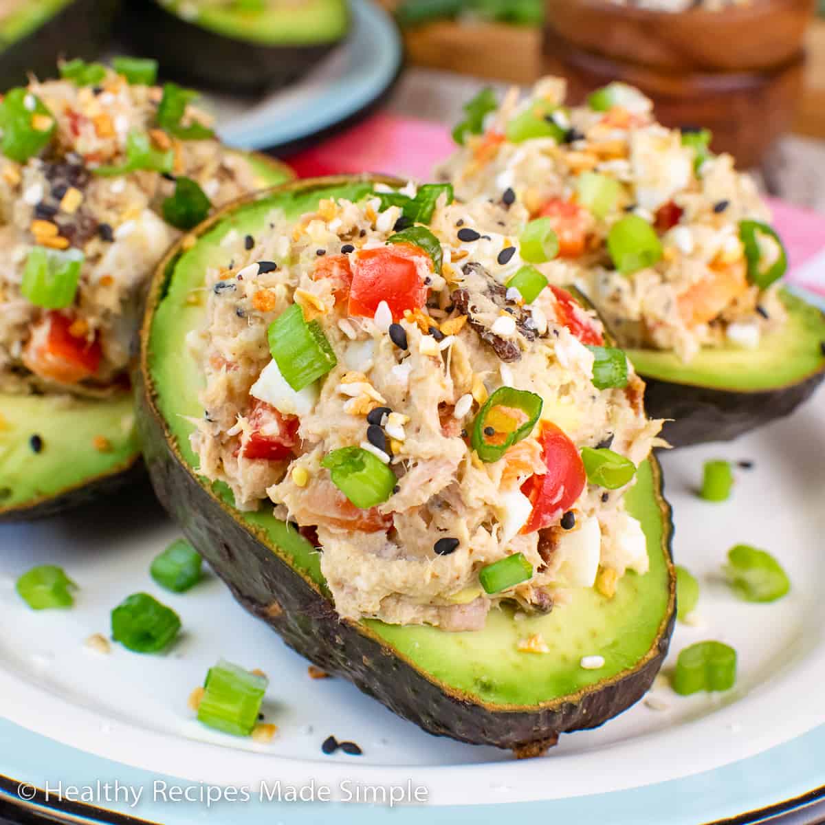 A square picture of tuna salad in an avocado.