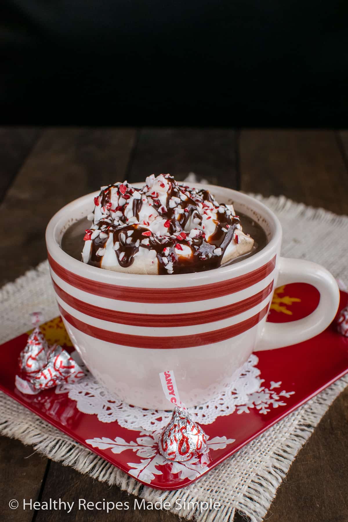 A white cup with red stripes filled with sugar free hot chocolate.