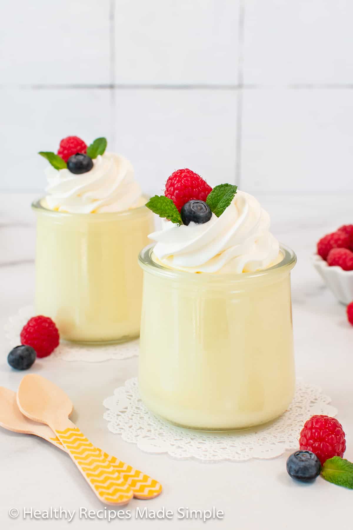 Two jars filled with creamy lemon gelatine.