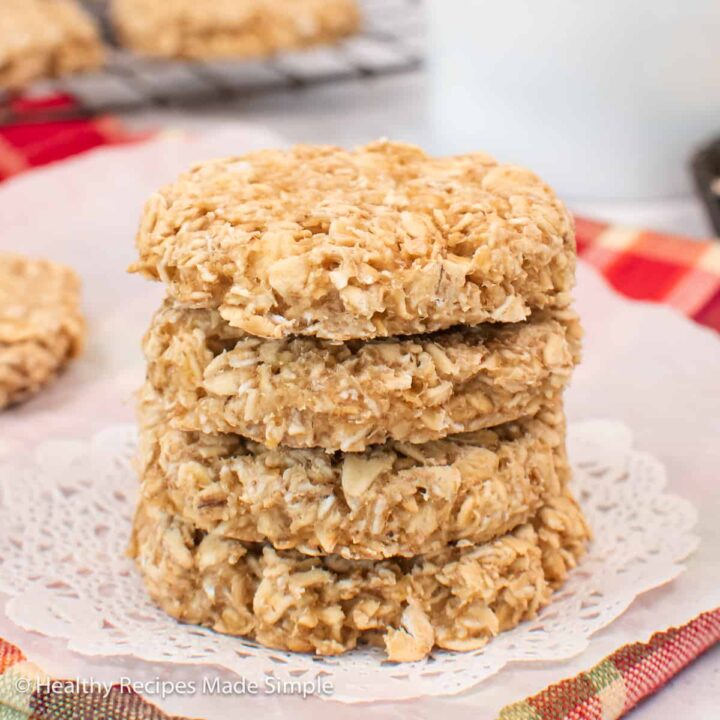 A stack of oatmeal cookies on parchment paper.