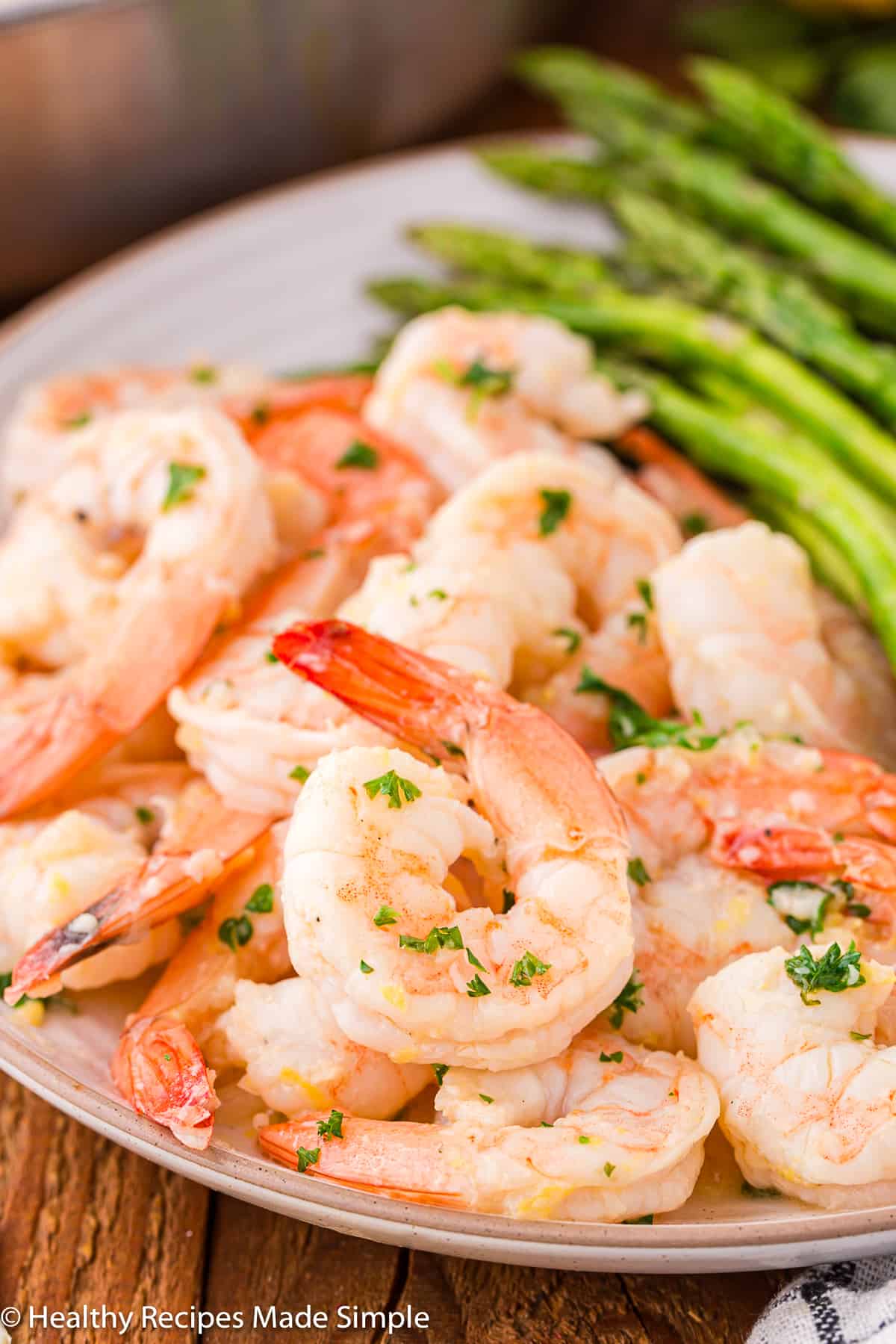 A plate with lemon garlic butter shrimp on it.