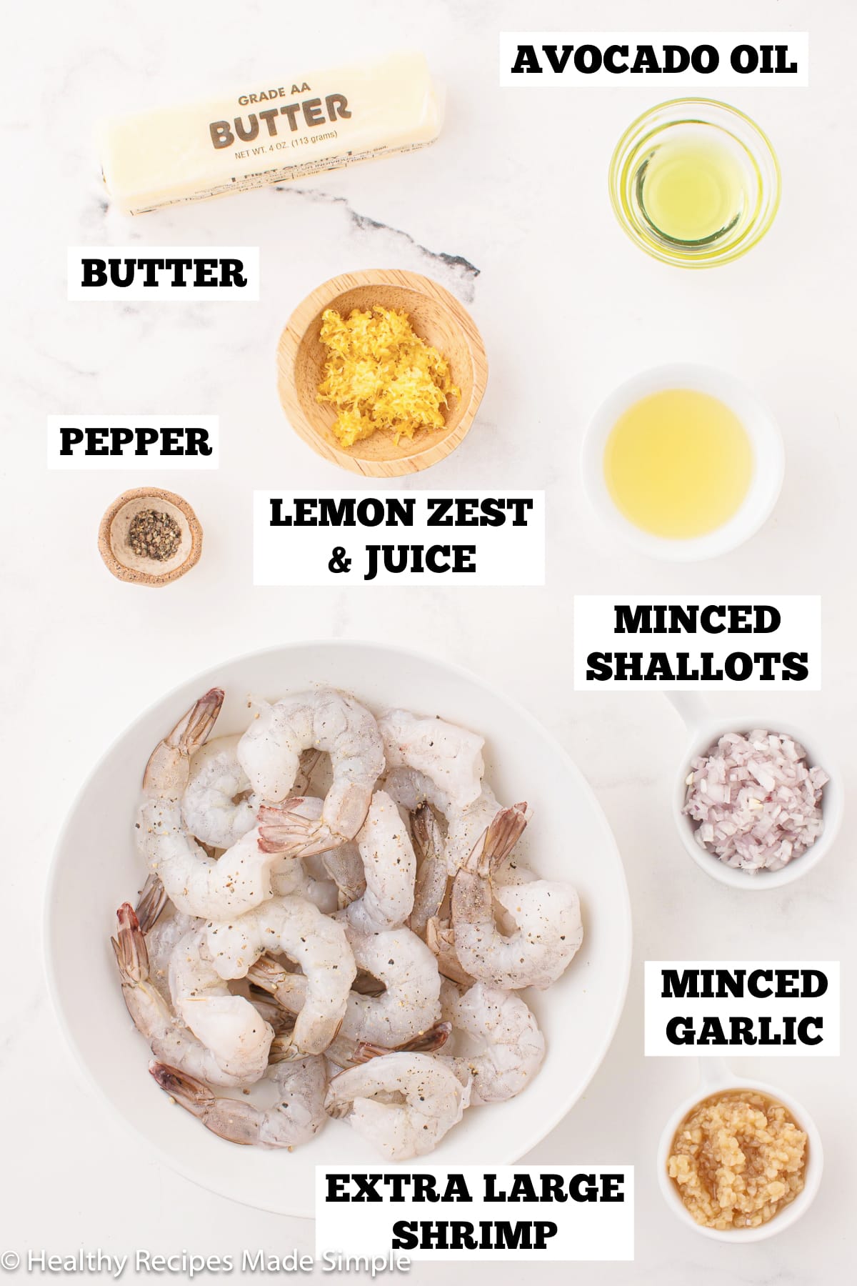 A white board with bowls of ingredients needed to make a healthy shrimp skillet.