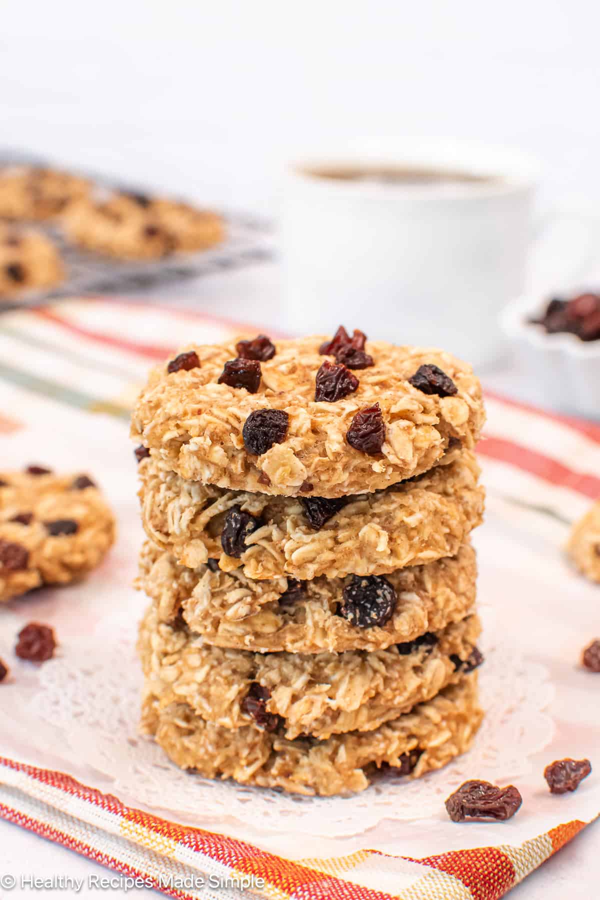 A stack of oatmeal cookies on a white paper.