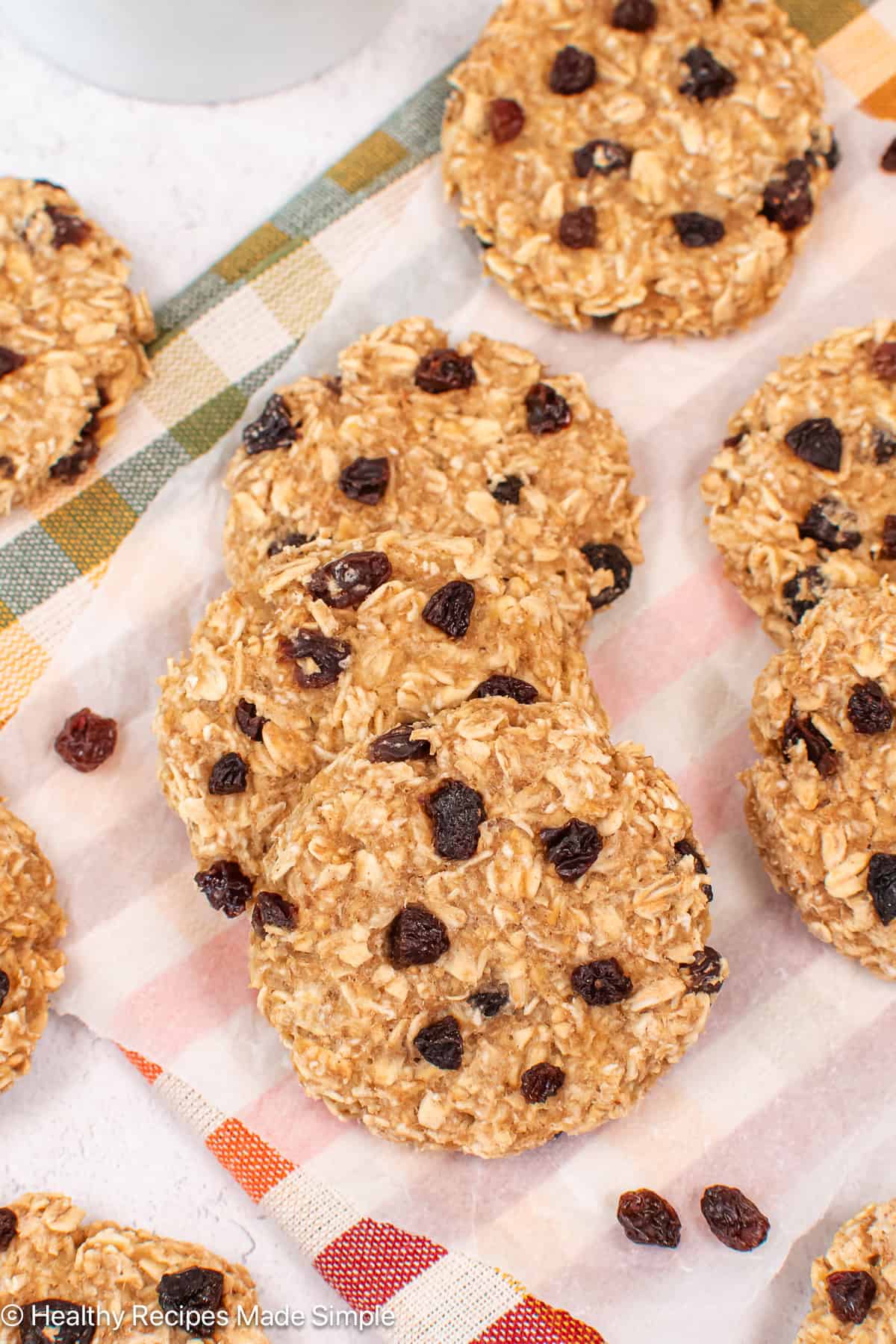 Applesauce oatmeal cookies with raisins on white paper.