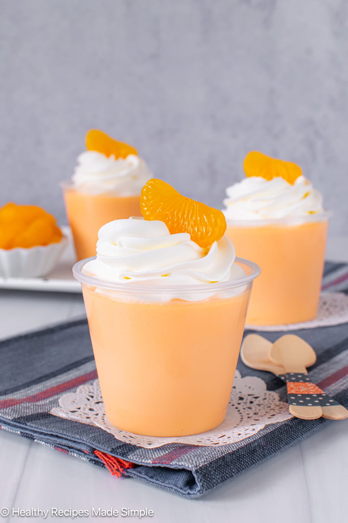 Three clear cups filled with a protein gelatin dessert.